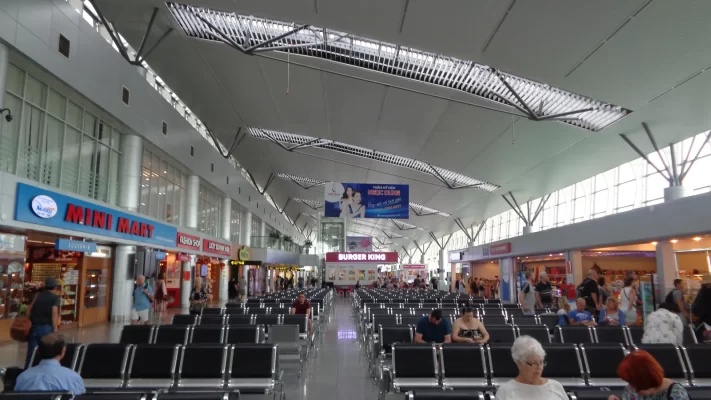 Inside the international terminal at Da Nang Airport, with rows of seating, shops and a high white ceiling
