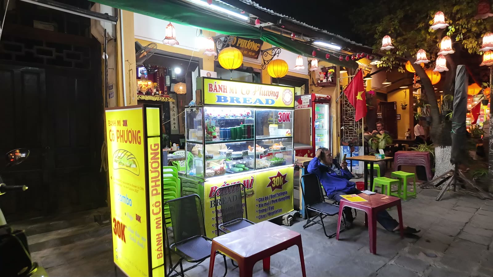 The Banh Mi Phuong shopfront in Hoi An on a January evening