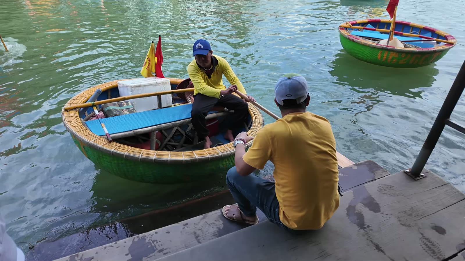 Basket boats and a boatman at the launching dock in the Bay Mau coconut forest near Hoi An