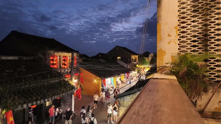 Lanterns lit along a street in Hoi An Ancient Town at dusk