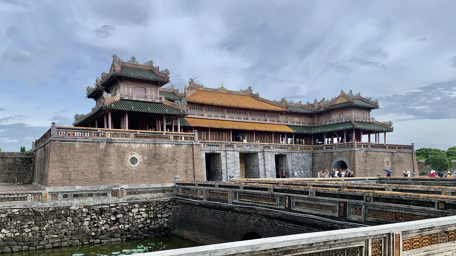 The Meridian Gate of the Imperial City in Hue, with its yellow-tiled upper pavilion above a brick base and moat