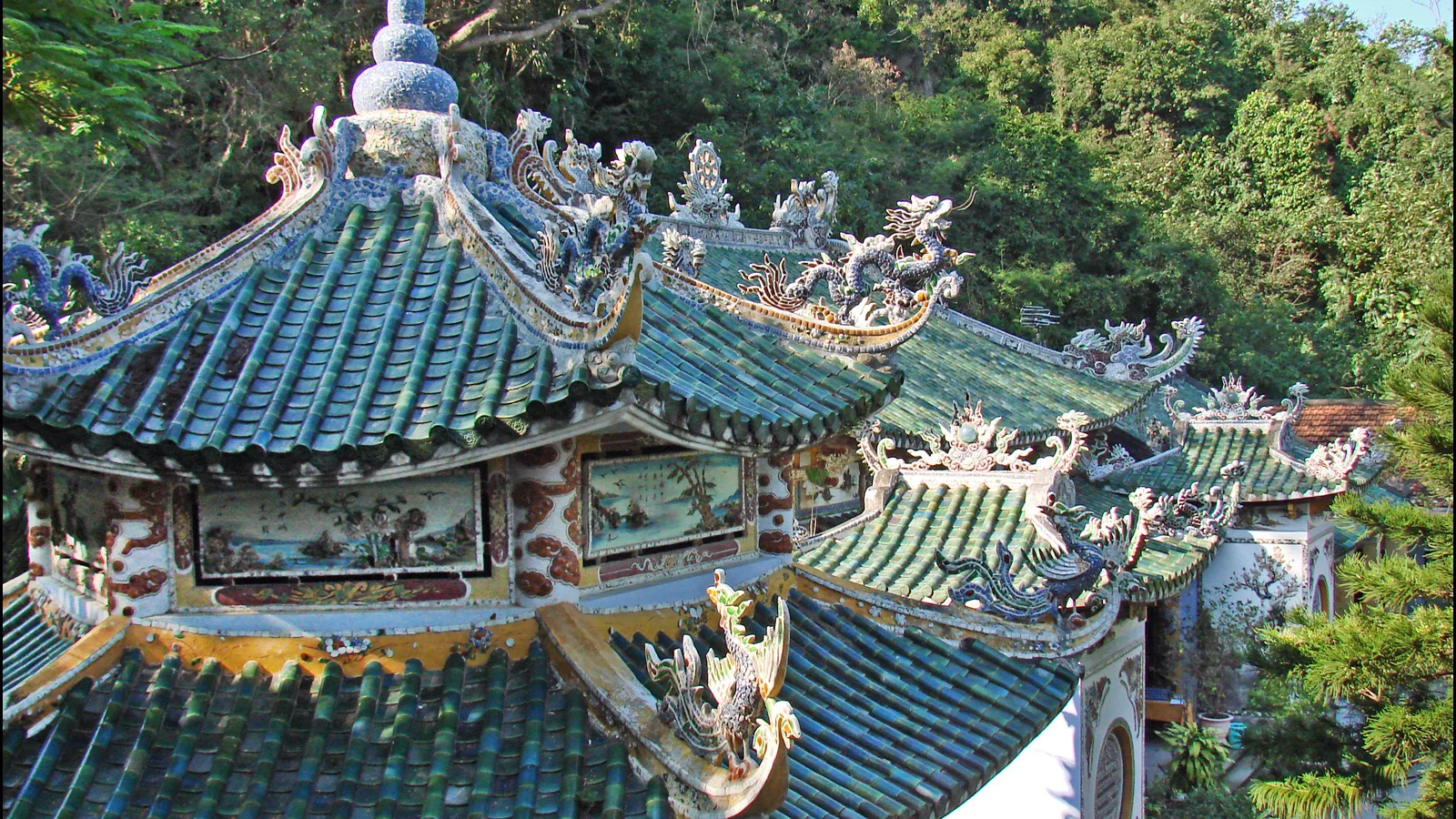 The ornate tiled roof of Tam Thai Pagoda on Thuy Son at the Marble Mountains, with dragons along the ridge