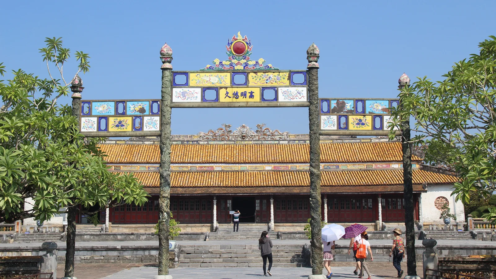 The ornate gateway and yellow-tiled roof of the Thai Hoa Palace in the Imperial City of Hue